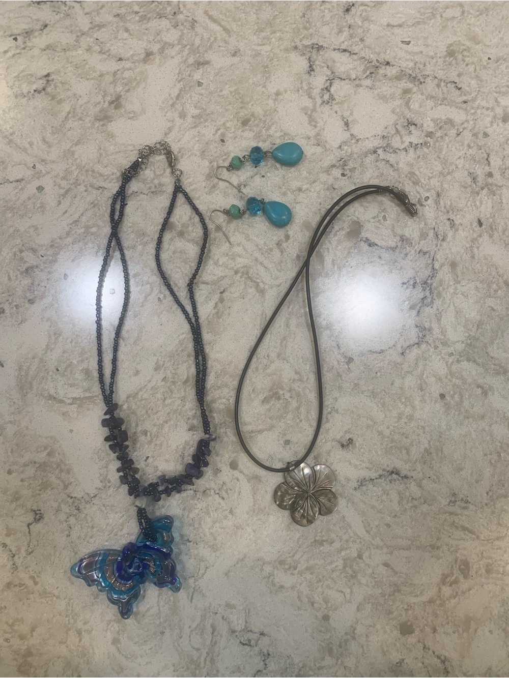 Blue Glass Butterfly necklace, hibiscus shell necklace and beaded earrings
